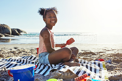 Buy stock photo Black child, smile and playing with sand at the beach for summer vacation, holiday or weekend in the outdoors. Portrait of happy African American little girl enjoying fun time with toys by the ocean