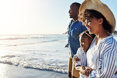 Buy stock photo Shot of an adorable little girl going for a walk with her parents on the beach