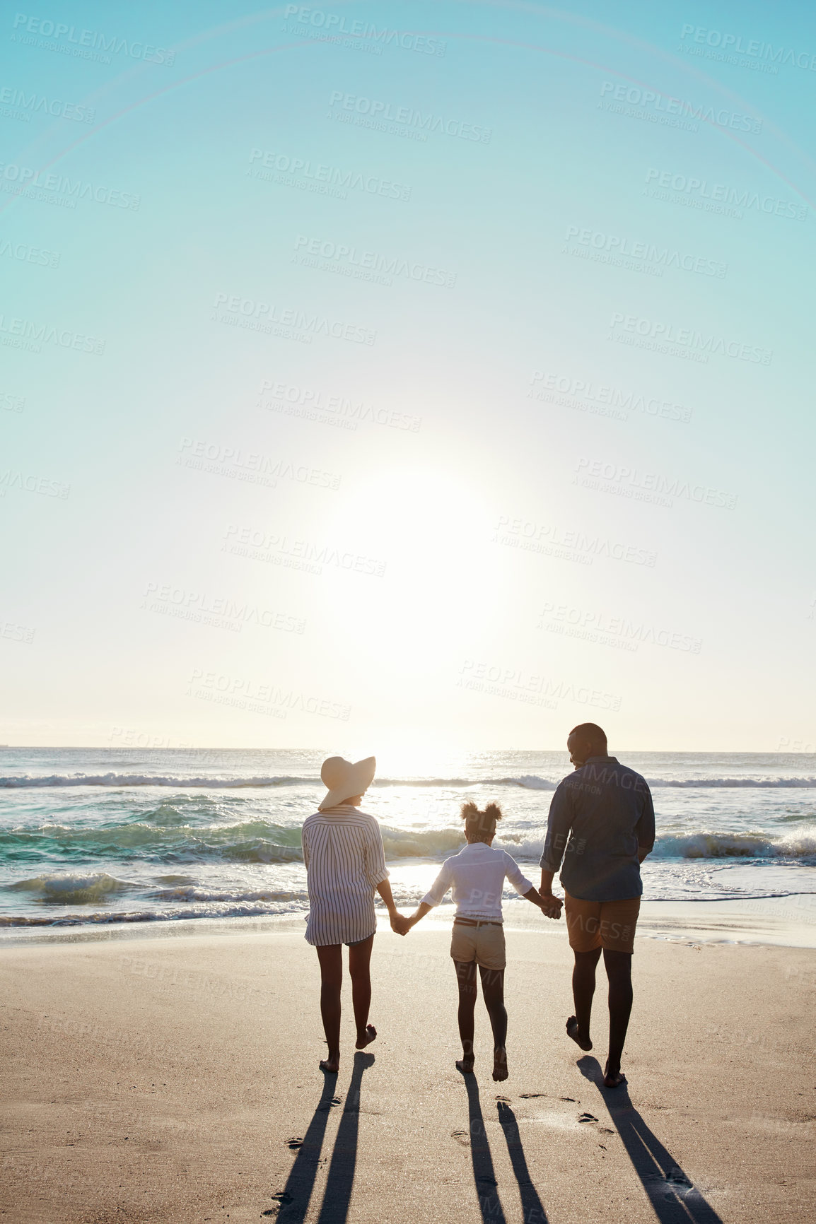 Buy stock photo Parents, girl and holding hands by ocean with back for bonding, walk or people in mockup space. Father, mother and daughter for connection, love or sunshine at beach for memory on vacation in Jamaica