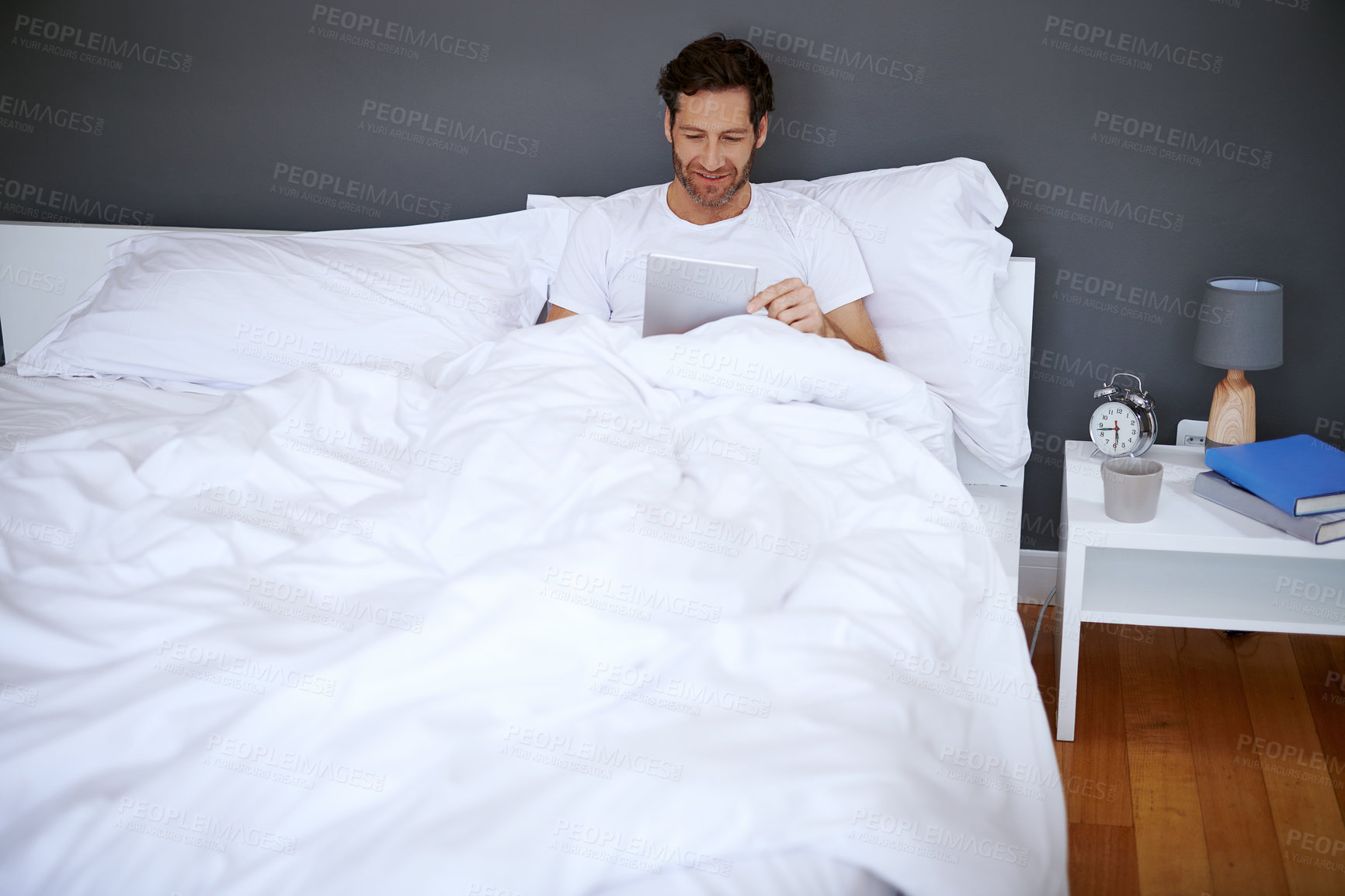 Buy stock photo Home, bed and man with internet on tablet for web search, communication or reading news on weekend. Media, app and male person with tech in house for digital connectivity, information or notification