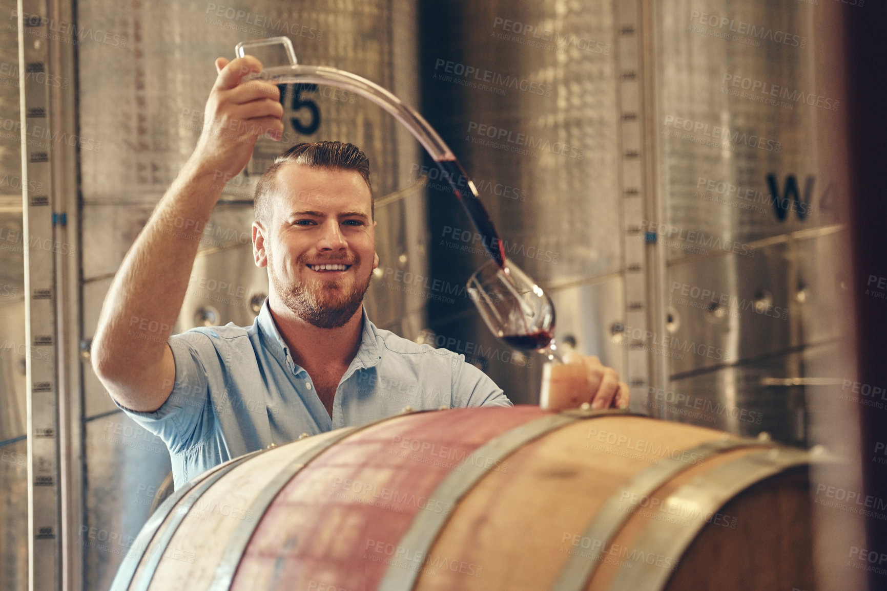 Buy stock photo Man, happy and wine maker with pouring in glass as manager for tasting, process and production. Portrait, winery and smile in confidence with product for alcohol manufacturing and craft in factory