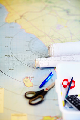 Buy stock photo High angle shot of a map and stationary lying on a desk inside a lifeguard office