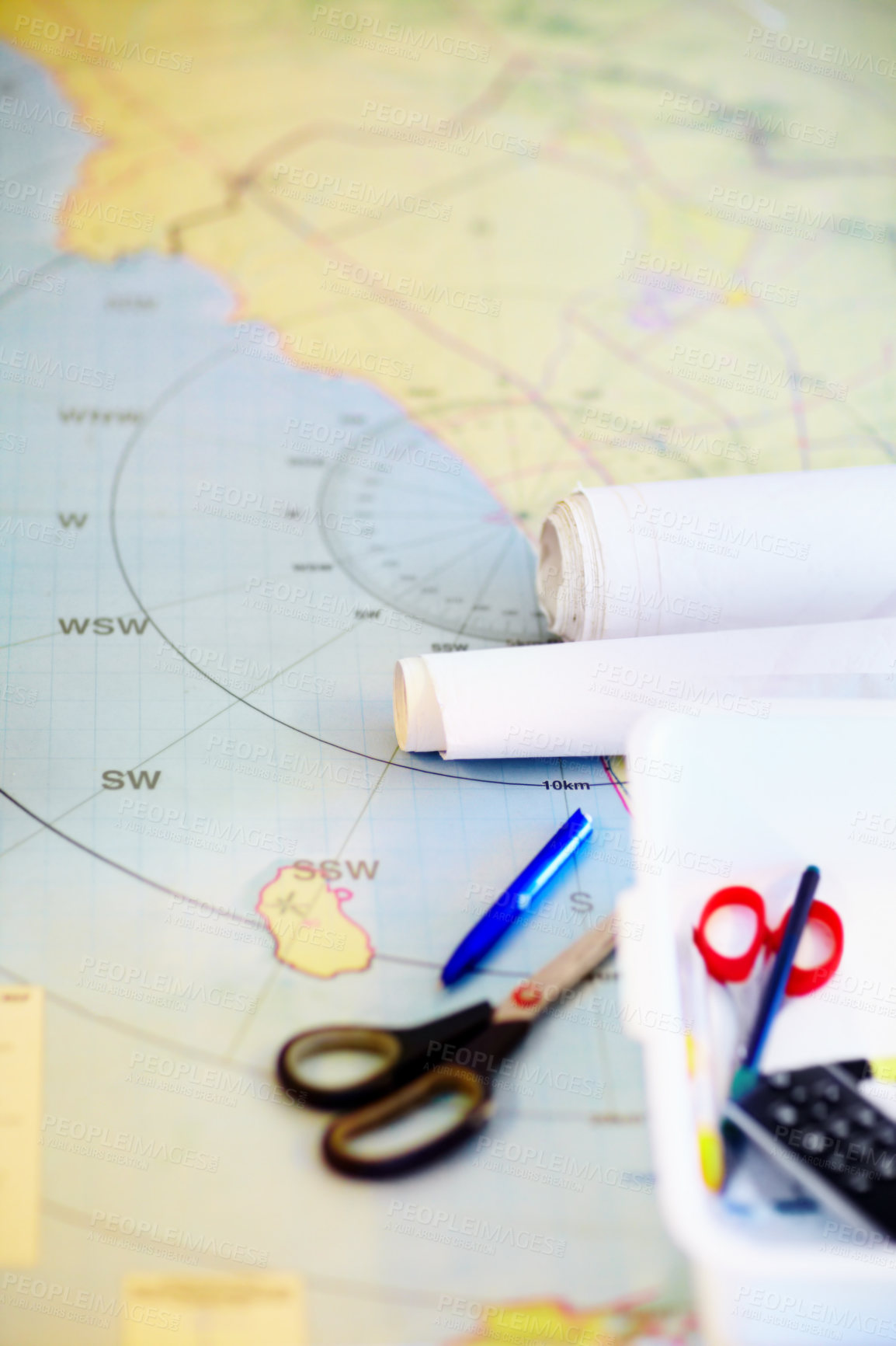 Buy stock photo High angle shot of a map and stationary lying on a desk inside a lifeguard office