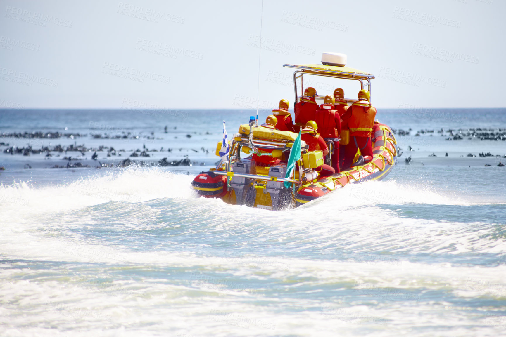 Buy stock photo Full length shot of a group of lifeguards heading out  to sea on a rescue mission