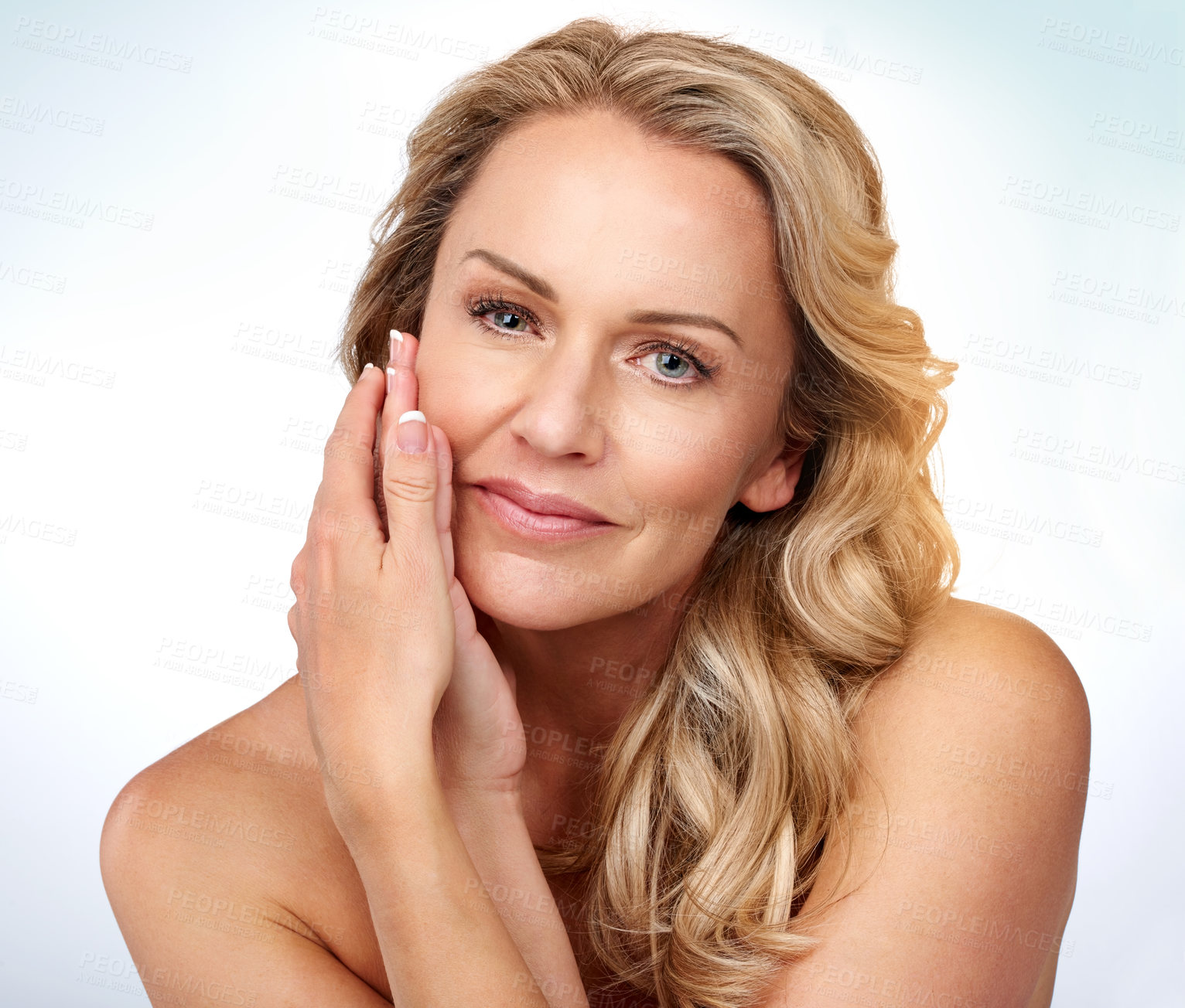 Buy stock photo Studio portrait of an attractive mature woman posing against a grey background