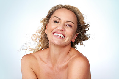 Buy stock photo Studio portrait of an attractive mature woman posing against a grey background