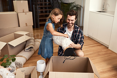 Buy stock photo Shot of a young father and his adorable little daughter on their moving day
