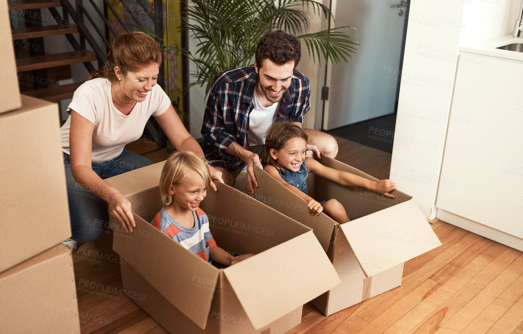 Buy stock photo Family, new house or excited children in boxes for real estate, property relocation or achievement on moving day. Parents, kids and fun in cardboard package with mortgage investment or home milestone