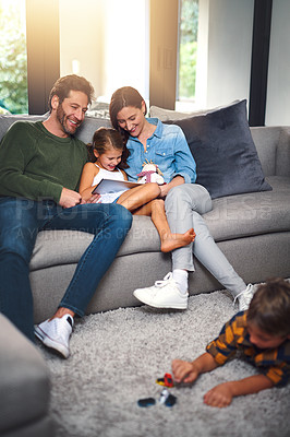 Buy stock photo Family, parents and children with tablet on sofa for educational games, platform and entertainment. Happy, home and girl with tech in living room by boy for digital learning, growth and development