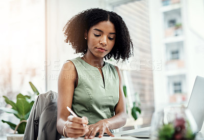 Buy stock photo Corporate, black business woman writing in book and at laptop sitting at desk in her office. Planning schedule, reminder and focused African female worker in workplace write notes on information