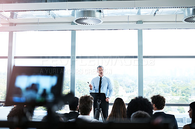 Buy stock photo Shot of a businessman giving a presentation at a conference