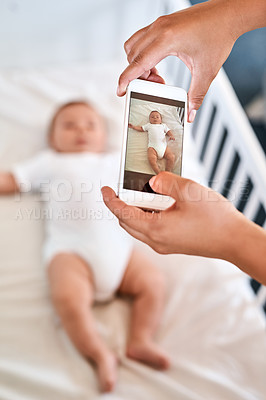 Buy stock photo Cropped shot of a mother taking a picture of her baby boy on a cellphone