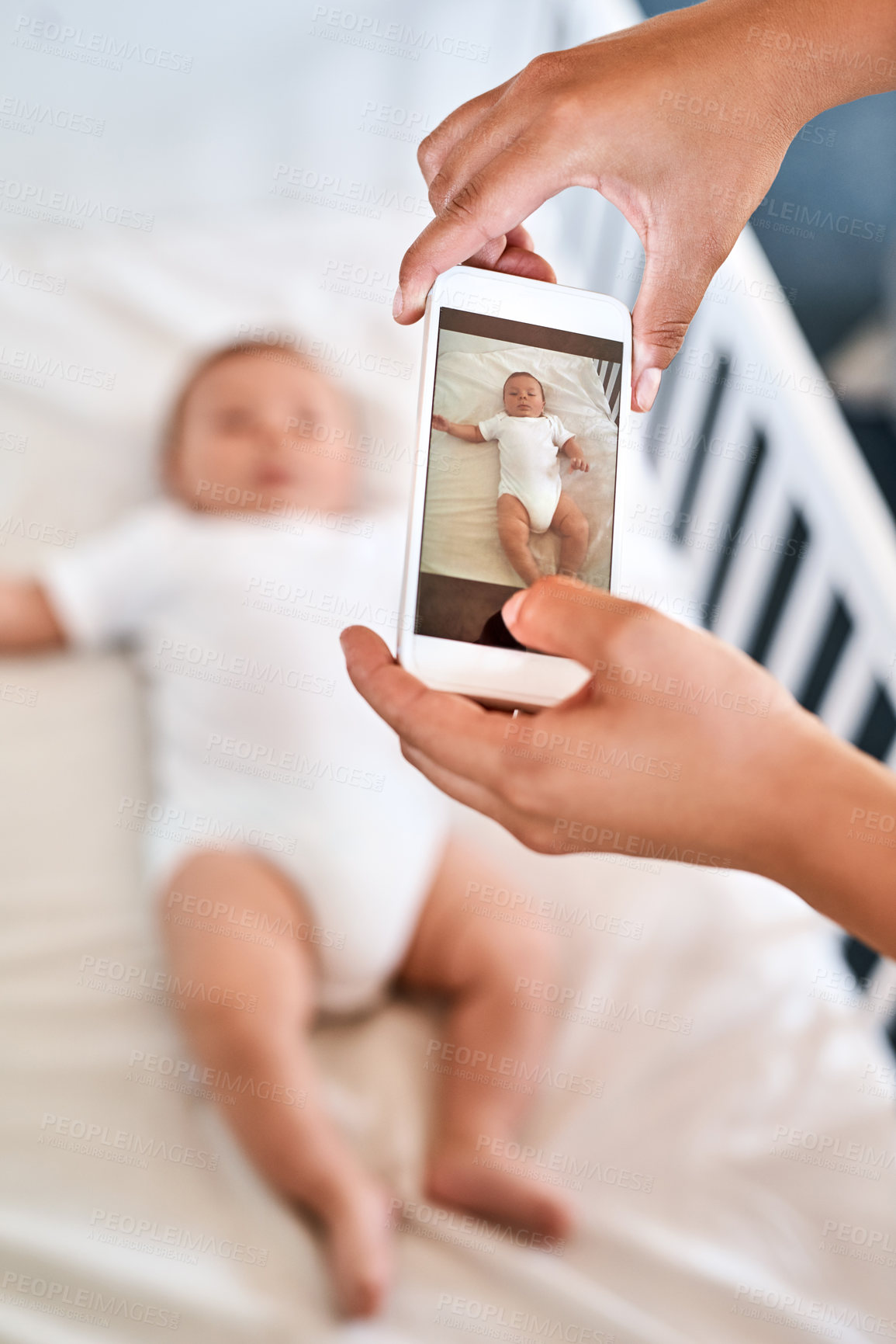 Buy stock photo Cropped shot of a mother taking a picture of her baby boy on a cellphone