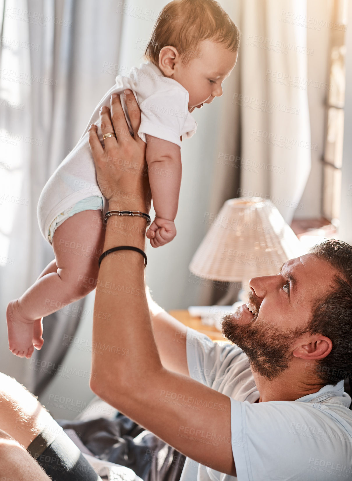 Buy stock photo Home, dad and baby in air for playing, growth and child development with single parent for bonding. Family, proud father and boy infant in house with lift game, comfort and energy with newborn son