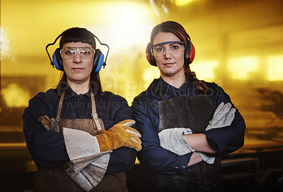 Buy stock photo Cropped portrait of two attractive young female artisans standing with their arms crossed in their workshop