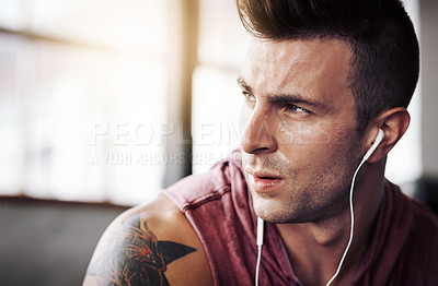 Buy stock photo Man, tired and music in gym for exercise, workout and wellness with radio and sweat. Training, thinking and male bodybuilder on break from cardio, fitness and earphones for listening to podcast