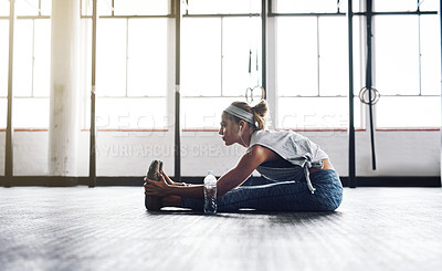 Buy stock photo Legs, stretching and training with woman on floor of gym for challenge, health or wellness. Exercise, fitness and warm up for workout with athlete getting ready for physical improvement routine