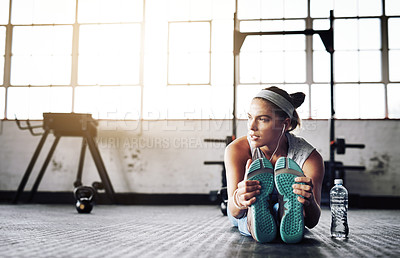 Buy stock photo Fitness, stretching and thinking with woman on floor of gym for health, improvement or wellness. Exercise, idea and warm up for leg workout with athlete getting ready for physical improvement routine