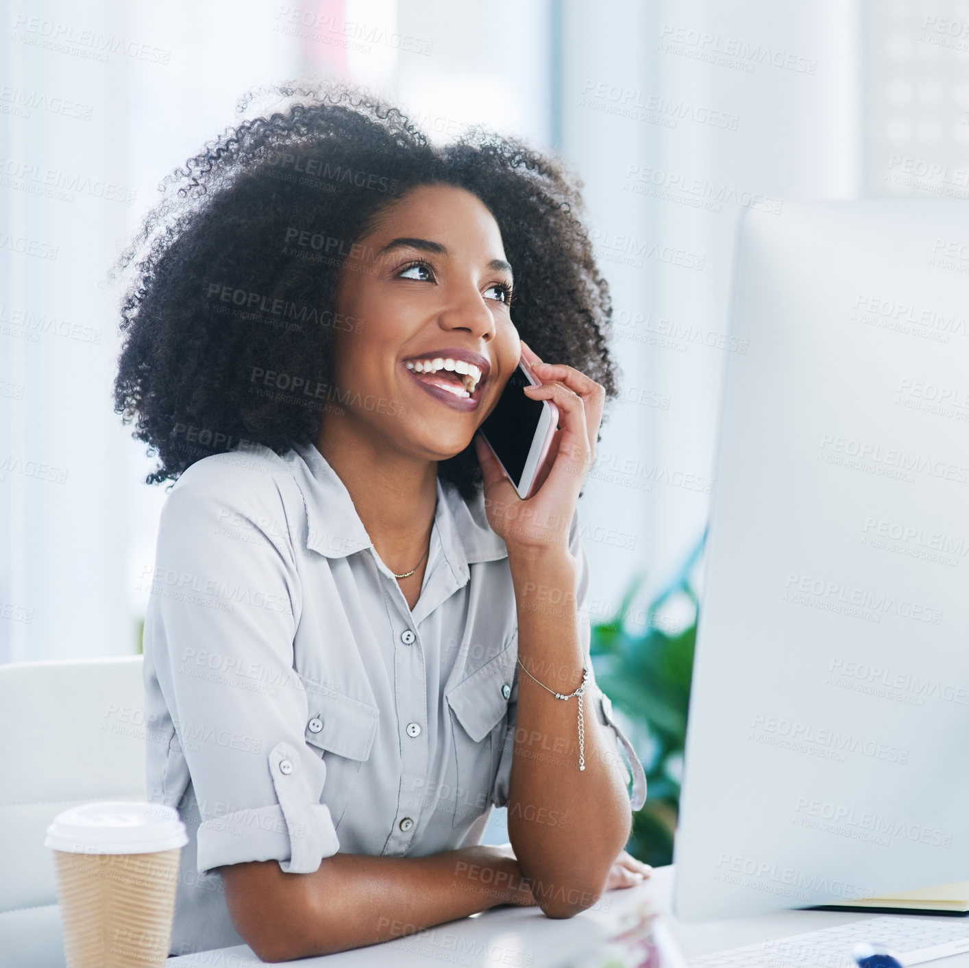 Buy stock photo Shot of a young businesswoman talking on a cellphone in an office