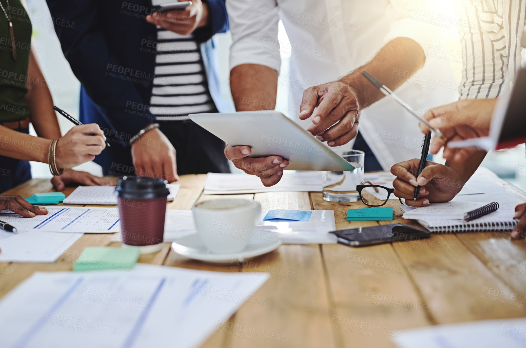 Buy stock photo Business people, hands and meeting with tablet and documents for project discussion at office. Group of employees in team discussion, conversation or paperwork with technology for brainstorming