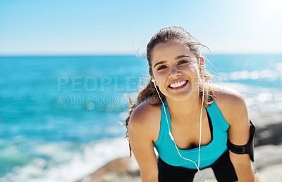 Buy stock photo Earphones, happy and portrait of woman by beach for running with music, podcast or radio online. Sports, tech and athlete streaming workout playlist for cardio exercise for marathon training by sea