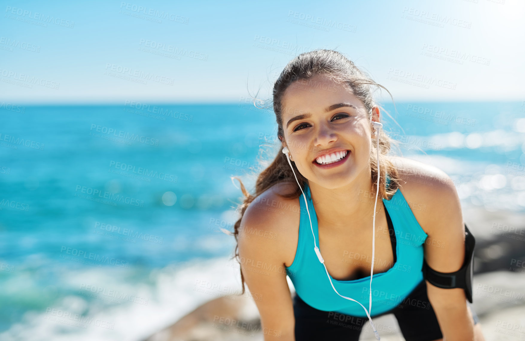 Buy stock photo Earphones, happy and portrait of woman by beach for running with music, podcast or radio online. Sports, tech and athlete streaming workout playlist for cardio exercise for marathon training by sea