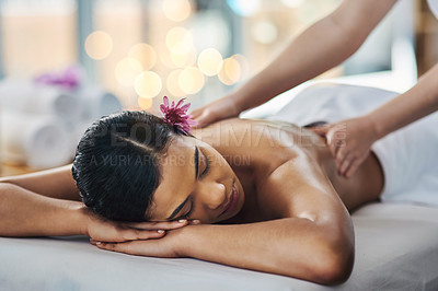 Buy stock photo Shot of an attractive young woman getting a massage at a spa