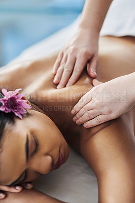 Buy stock photo Shot of an attractive young woman getting a massage at a spa