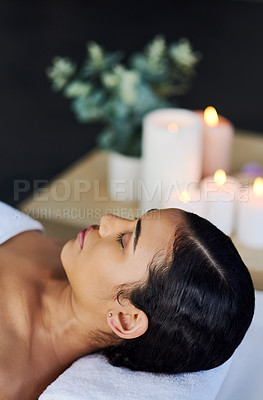 Buy stock photo Shot of an attractive young woman relaxing on a massage table at a spa