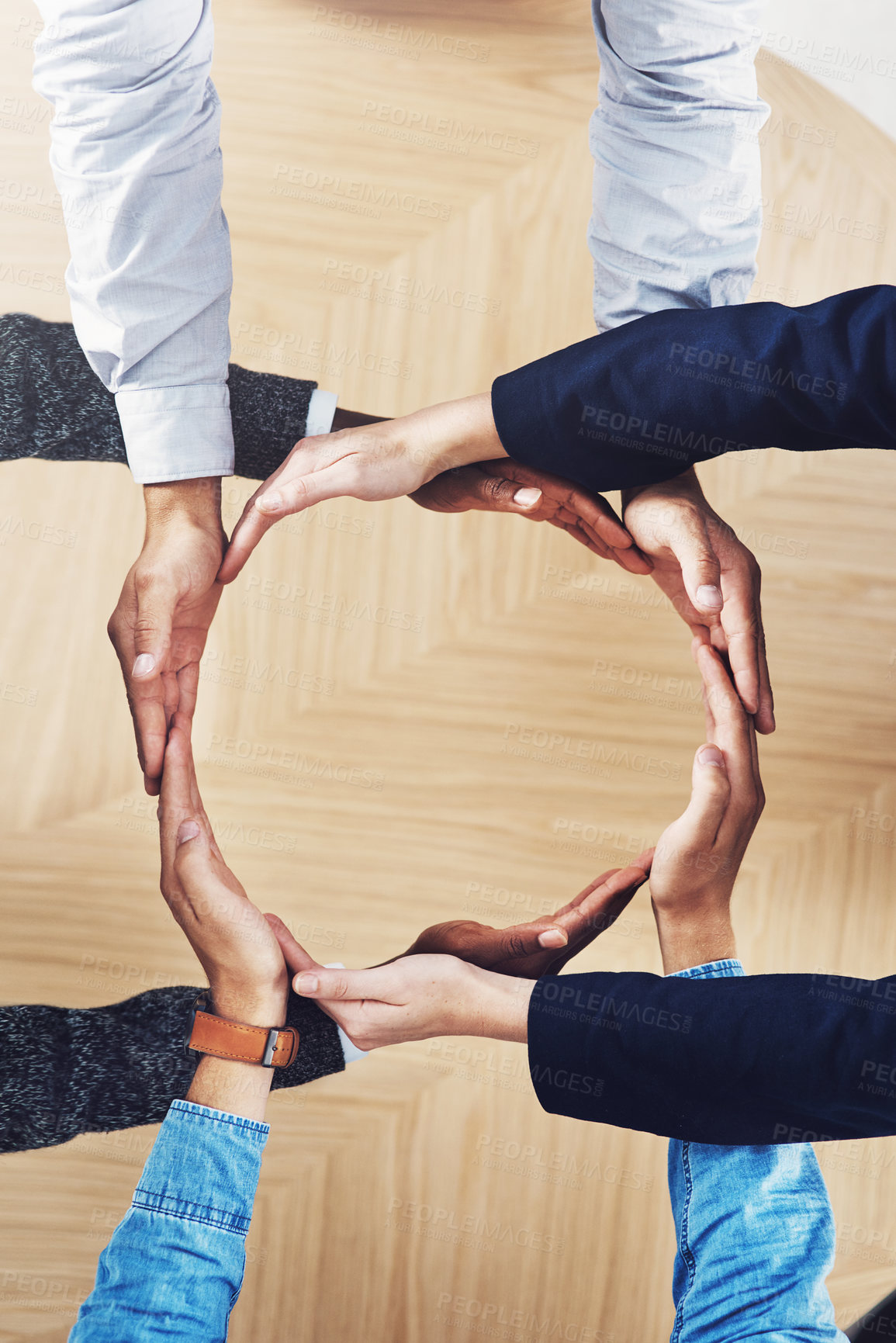 Buy stock photo High angle shot of a group of unidentifiable businesspeople forming a circle with their hands