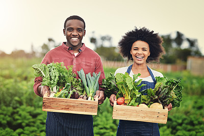 Buy stock photo Shot of young farmers tending to their crops