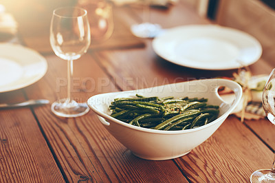 Buy stock photo Thanksgiving, green beans and food with a place setting on a dining room table for a celebration event. Party, dish and dinner with a bowl on a wooden surface in celebration or holiday tradition