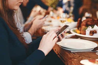 Buy stock photo Closeup, woman and phone chatting at dinner on social media, web or app for communication at party. Girl, smartphone and internet at table, lunch or celebration in restaurant, home or thanksgiving