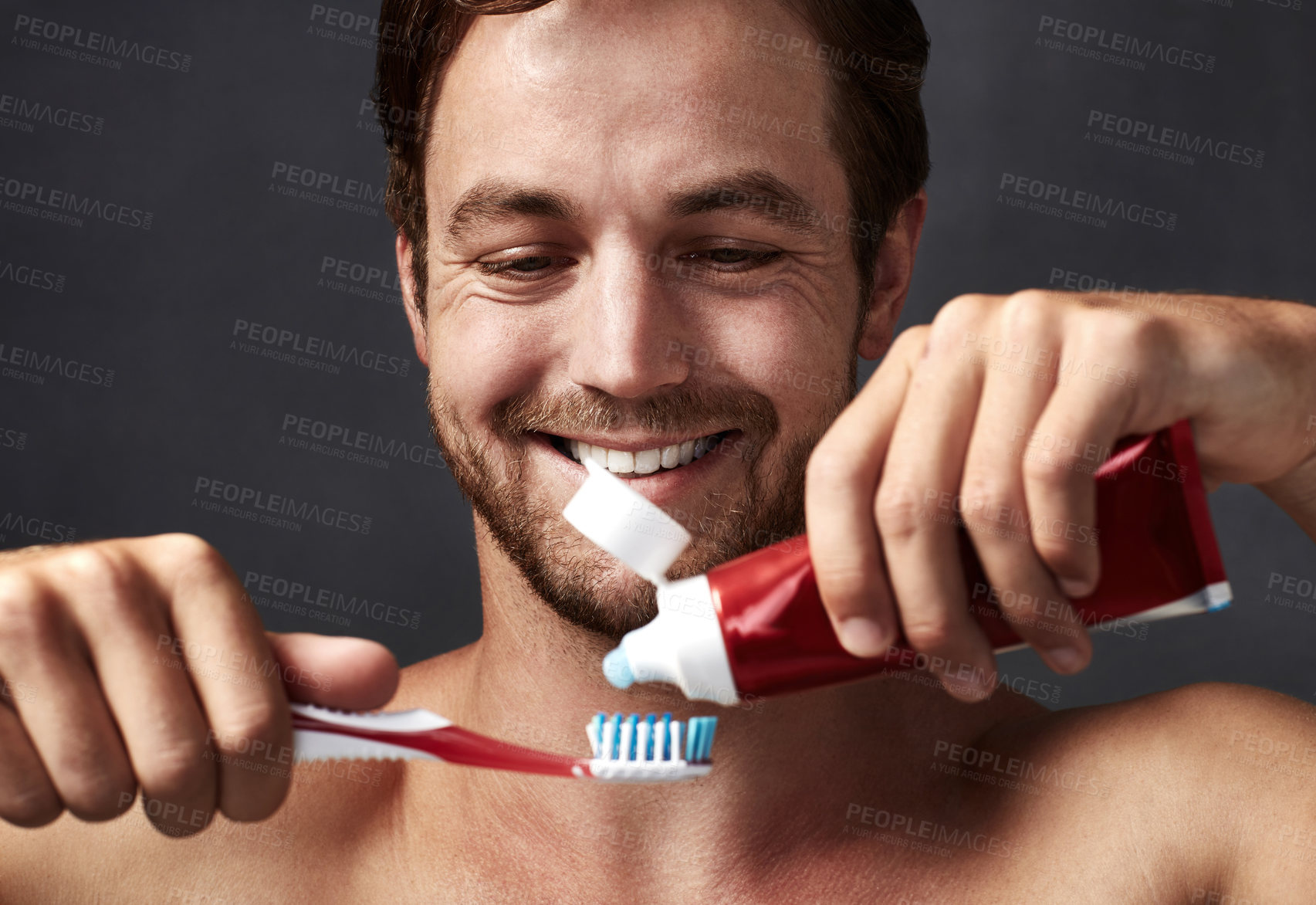 Buy stock photo Smile, toothbrush and toothpaste with man in studio isolated on blue background for dental care. Brushing teeth, face and oral hygiene with happy person in bathroom, cleaning mouth for protection