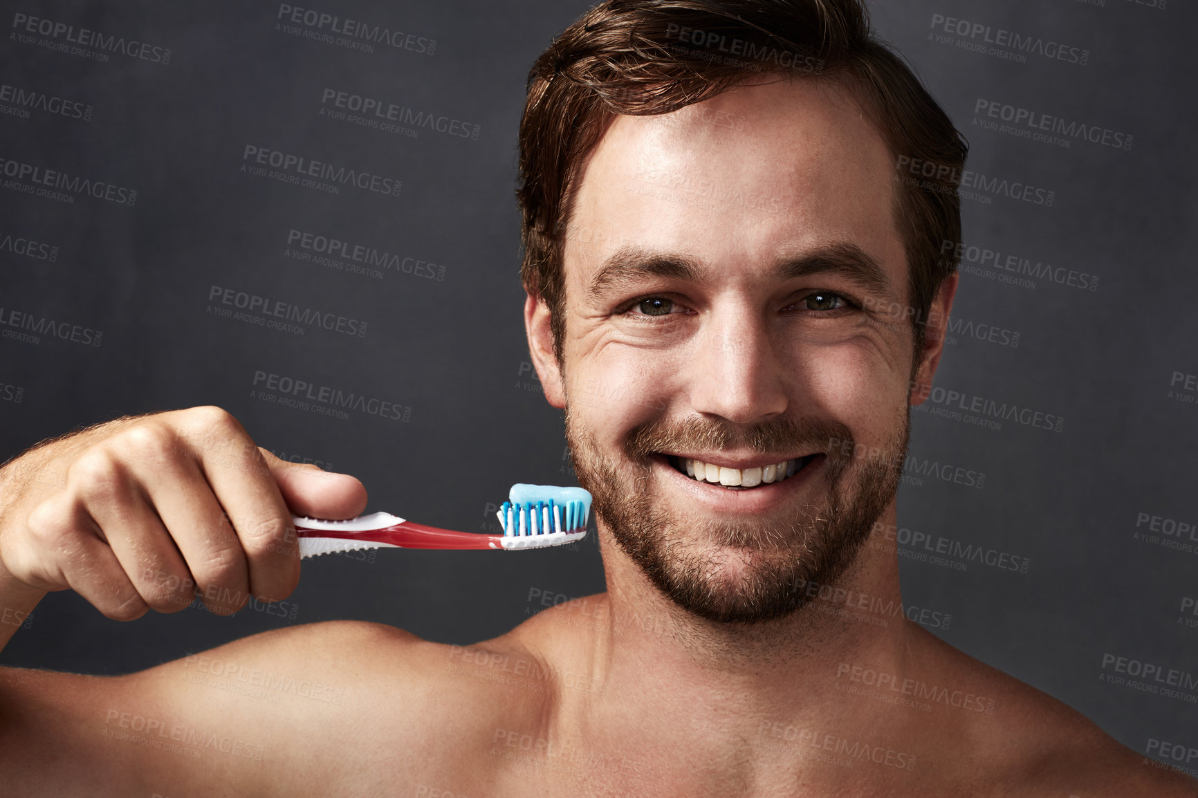 Buy stock photo Portrait, toothbrush and toothpaste with man in studio isolated on blue background for dental care. Brushing teeth, face and oral hygiene with person in bathroom, cleaning mouth for protection