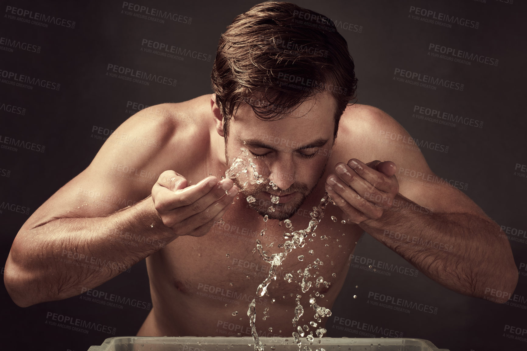 Buy stock photo Hygiene, man and skincare with water splash on face in studio background for cleaning, fresh and grooming. Male person, cosmetics and shirtless isolated on backdrop for wellness and dermatology