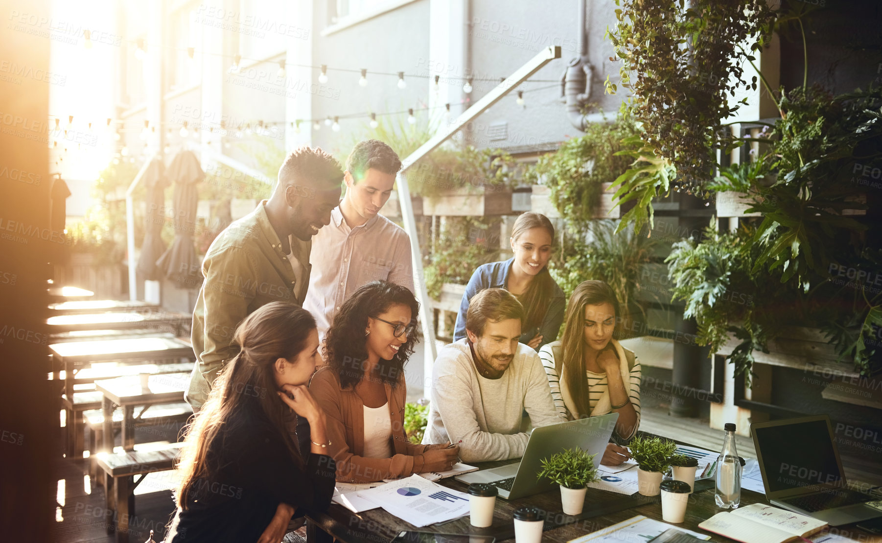 Buy stock photo Cropped shot of a group of colleagues having a meeting outside at a cafe