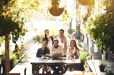 Buy stock photo Cropped portrait of a team of colleagues using a laptop together during a meeting at an outdoor cafe