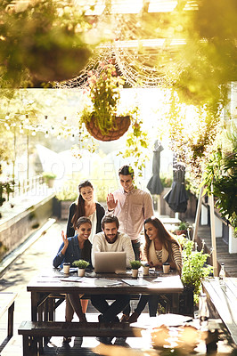 Buy stock photo Cropped shot of a team of colleagues using a laptop together during a meeting at an outdoor cafe