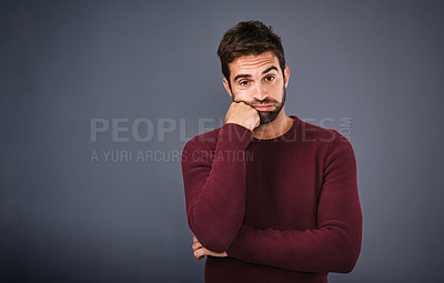 Buy stock photo Studio shot of a handsome young man looking bored against a gray background