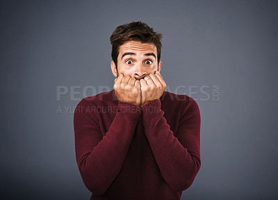 Buy stock photo Fear, thinking and portrait of man in studio, anxiety and biting of nails for stress, worry and scared. Gray background, mockup space and person with terror for nightmare of fail in test of company