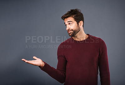 Buy stock photo Man, palm and suggestion with mockup for advertising, decision or selection on a gray studio background. Male person or young model showing deal or feedback with hand out in presentation or marketing