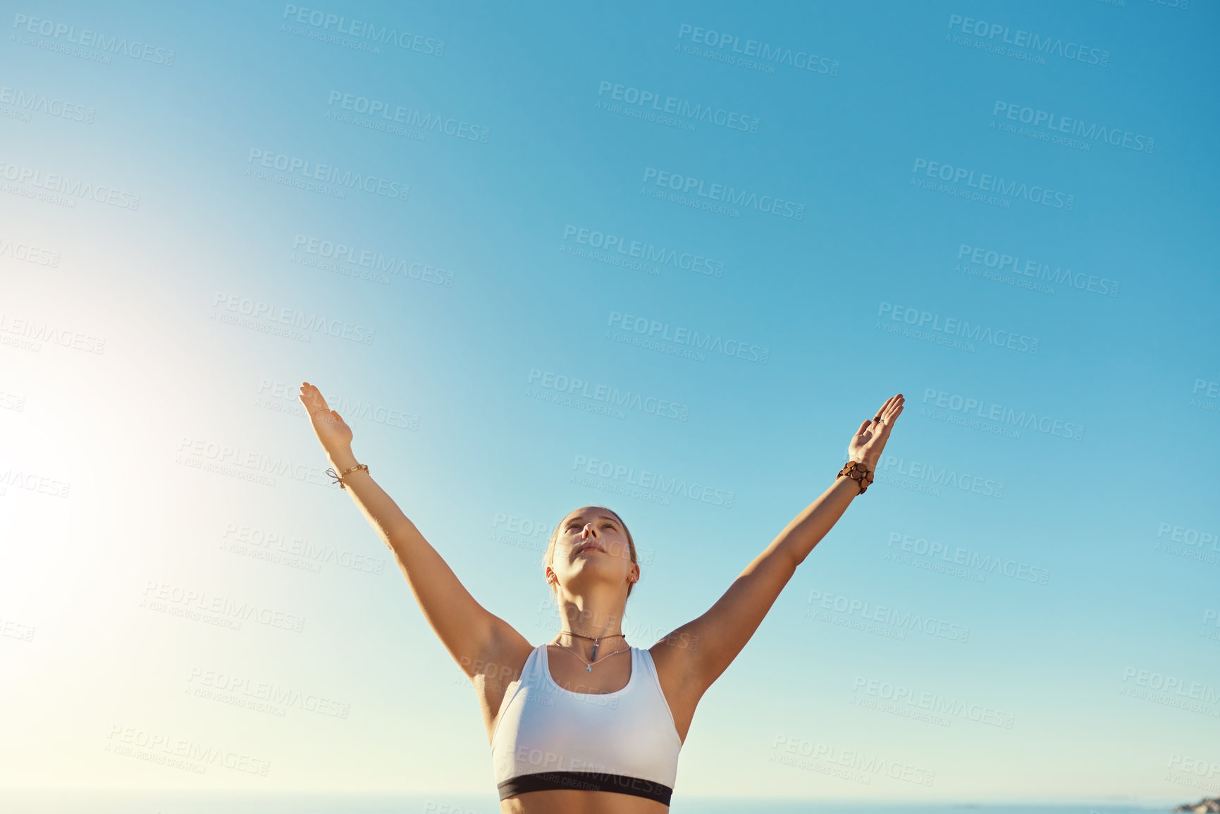 Buy stock photo Shot of an athletic young woman practicing yoga on the beach