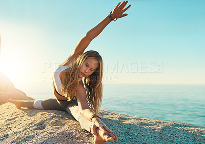 Buy stock photo Yoga, stretching and woman by ocean for wellness, health and mindfulness in nature. Morning, pilates and person on rock by sea for exercise, training and workout for fitness, balance and flexibility