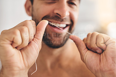 Buy stock photo Hands, face and man flossing teeth at home for dental health, plaque and gingivitis on gums. Closeup of guy, oral thread and cleaning mouth for fresh breath, tooth hygiene and habit to care for smile