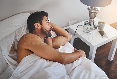 Buy stock photo Wake up, waiting and tired man in bedroom with alarm clock, insomnia or anxiety in hotel or house. Male person, sleeping or nap in home for new day, start and begin routine for appointment or Monday