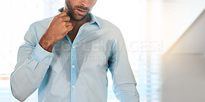 Buy stock photo Cropped shot of an unrecognizable sweaty man dressing himself in his bedroom at home