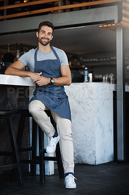 Buy stock photo Portrait, smile and man in restaurant, apron and waiter with confidence, luxury dining or hospitality. Face, happy person or leaning on counter with service industry, professional or server in cafe