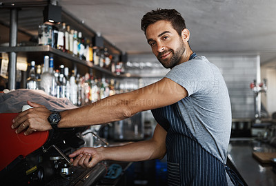 Buy stock photo Shot of a young man operating the coffee machine at a cafe