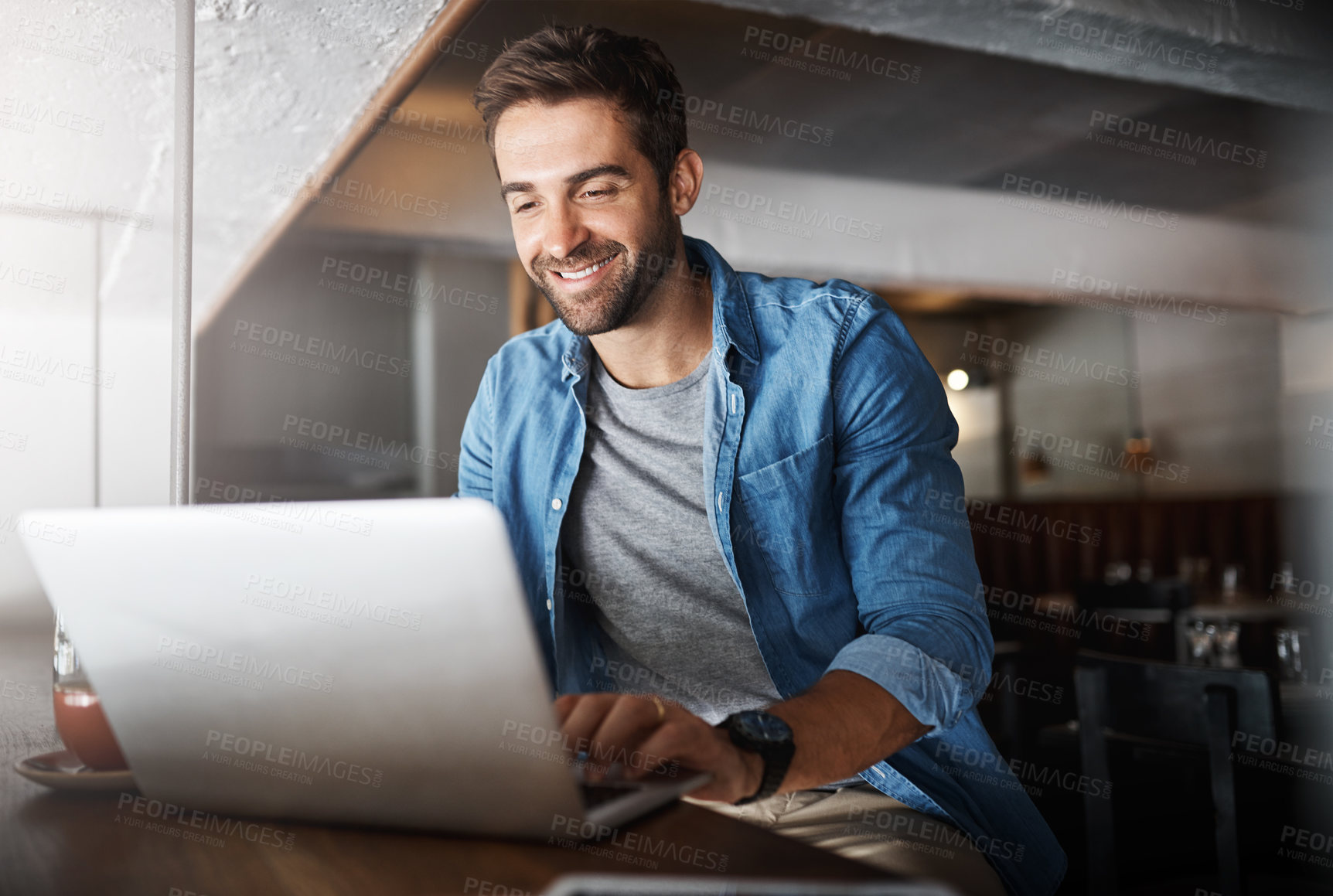 Buy stock photo Laptop, remote work and typing with man in coffee shop for networking or online research. Computer, freelance employment and smile of happy customer in cafe or restaurant for hospitality or service